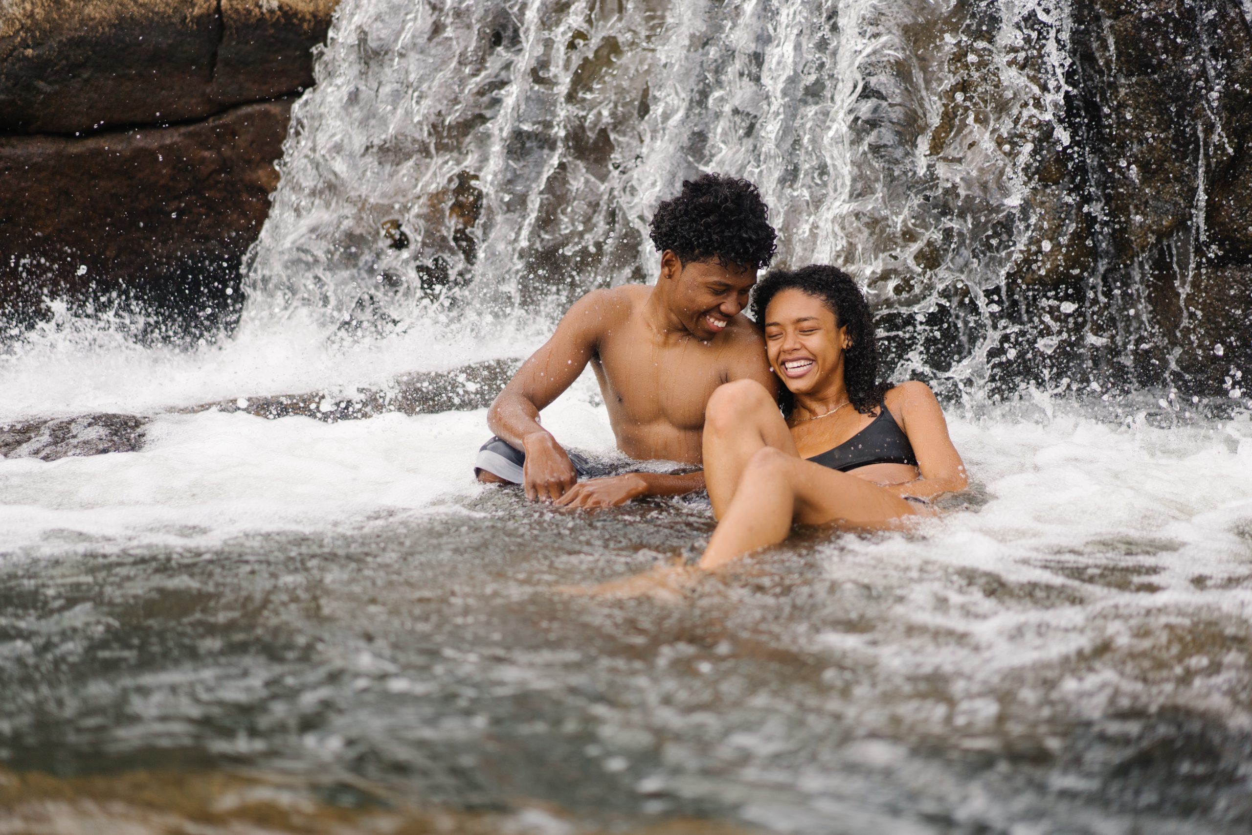 couple enjoying honeymoon at a waterfall