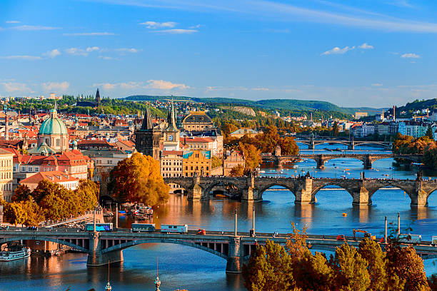 View of the Vltava River and Charle bridge with red foliage